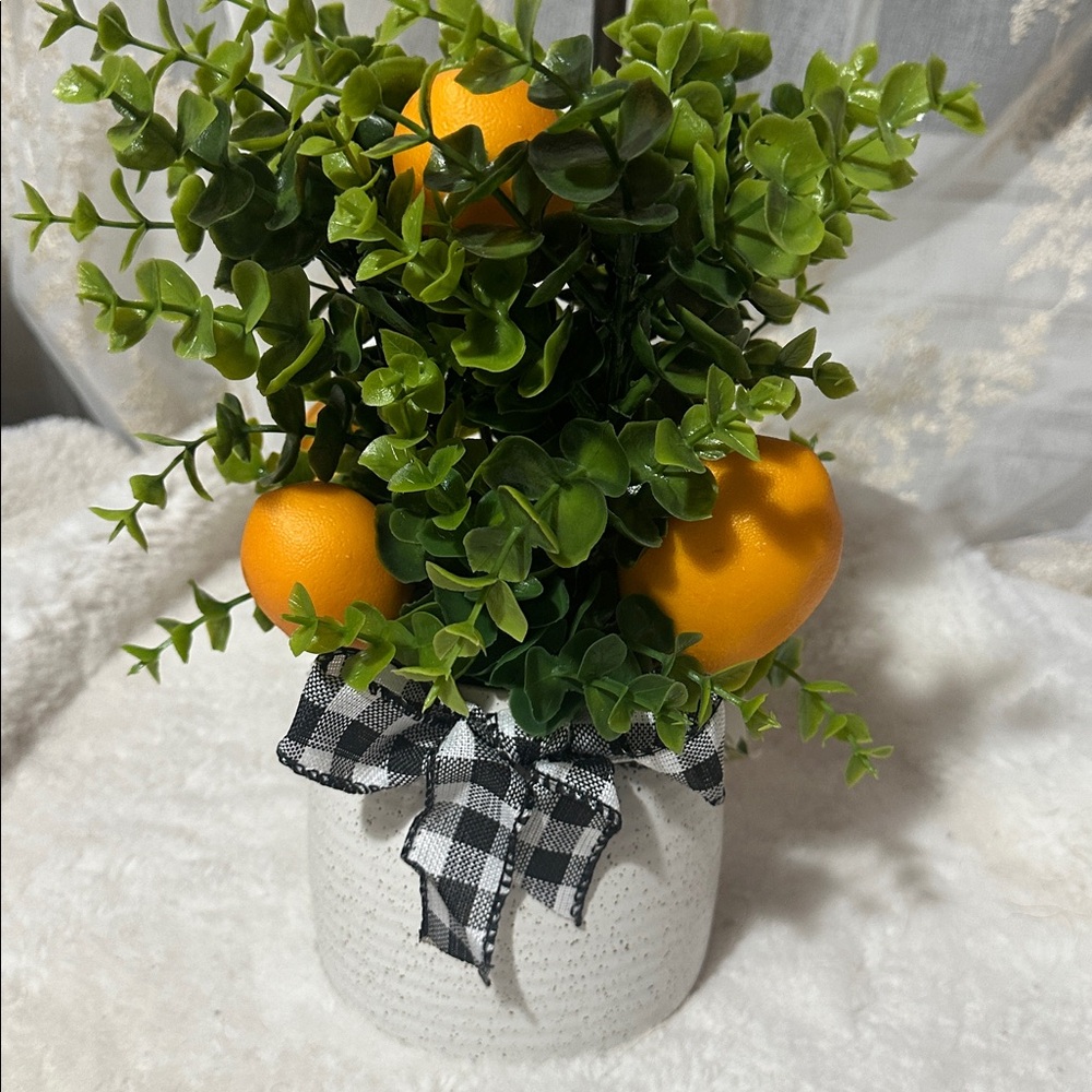 Orange fruit greenery in ceramic pot